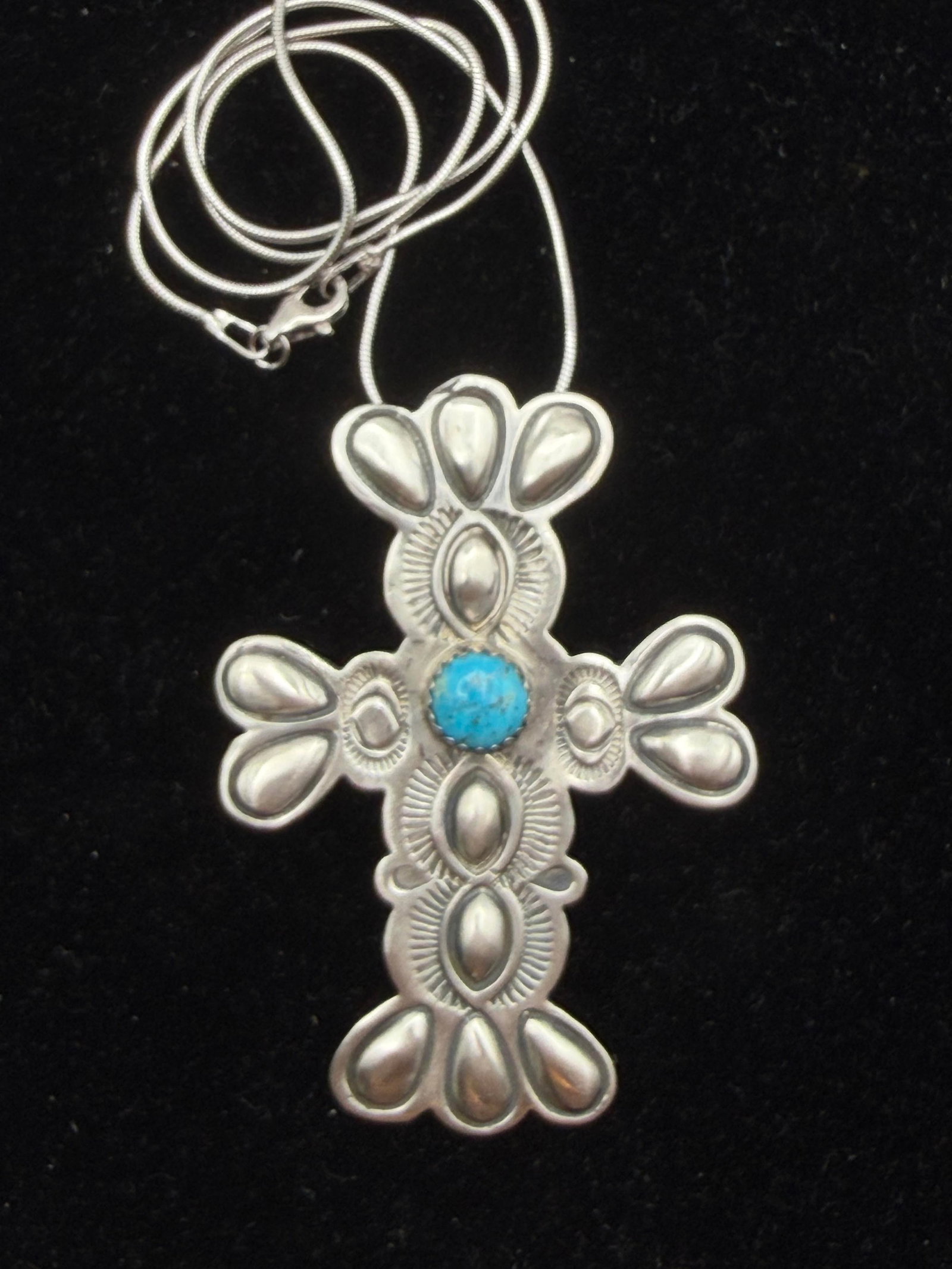 HASTEEN STERLING NAVAJO TURQUOISE CROSS NECKLACE: NEW OLD STOCK NATIVE AMERICAN HANDMADE STAMPED TURQUOISE CROSS PENDANT. SIGNED "T HASTEEN" MARKED TESTED STERLING SILVER. PENDANT IS 2.25" X 1.5". CHAIN IS 16". WEIGHS 16.6 GRAMS TOTAL. WITH IMPERIAL 