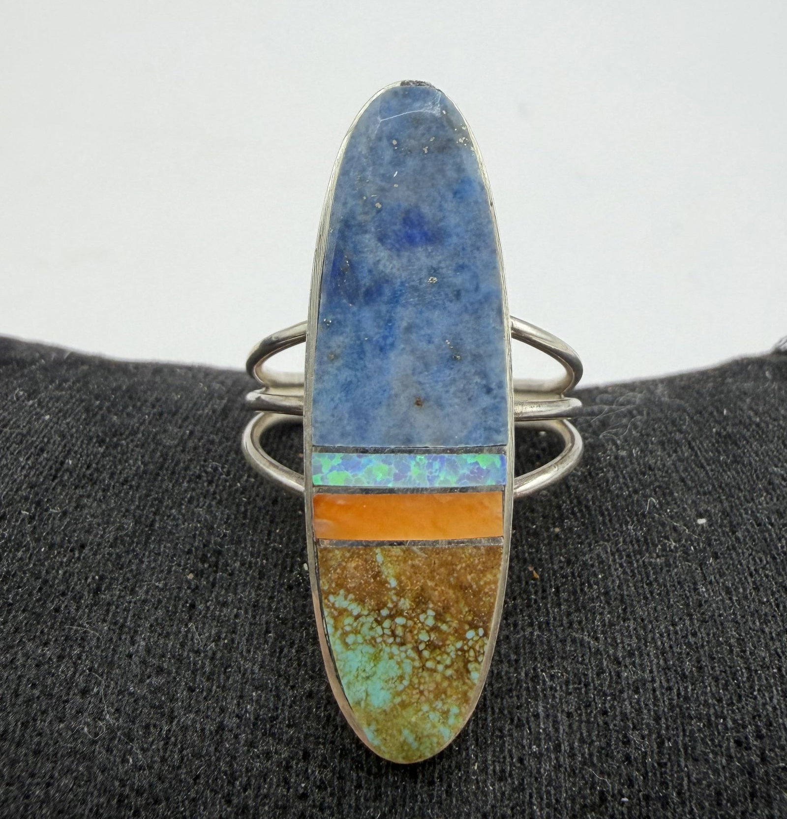 HAROLD SMITH STERLING NAVAJO TURQUOISE OPAL RING: NEW OLD STOCK NATIVE AMERICAN HANDMADE RING WITH INLAID SHELL LAPIS OPAL AND TURQUOISE. SIGNED MARKED TESTED STERLING SILVER. FACE OF RING IS 1.25" NORTH SOUTH. WEIGHS 5.6 GRAMS. RING SIZE 7.5. WITH I