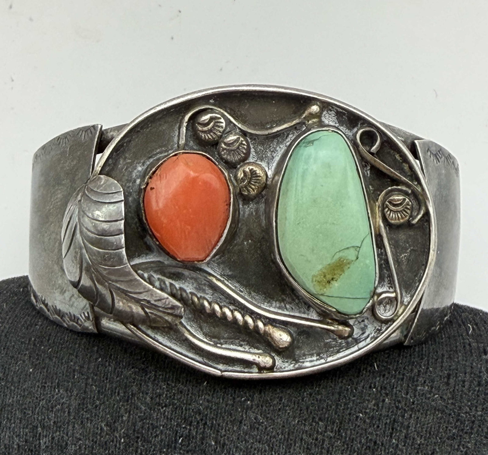 "DB" OLD PAWN STERLING NAVAJO RED CORAL BRACELET: VINTAGE NATIVE AMERICAN HANDMADE TURQUOISE CUFF BRACELET. SIGNED "DB" POSSIBLY DANIEL BENALLY. INTRICATE HALLMARK. TURQUOISE HAS CRACKS. TESTED STERLING SILVER. GAP IS 1.25" FLEXIBLE AND FITS 6.5"