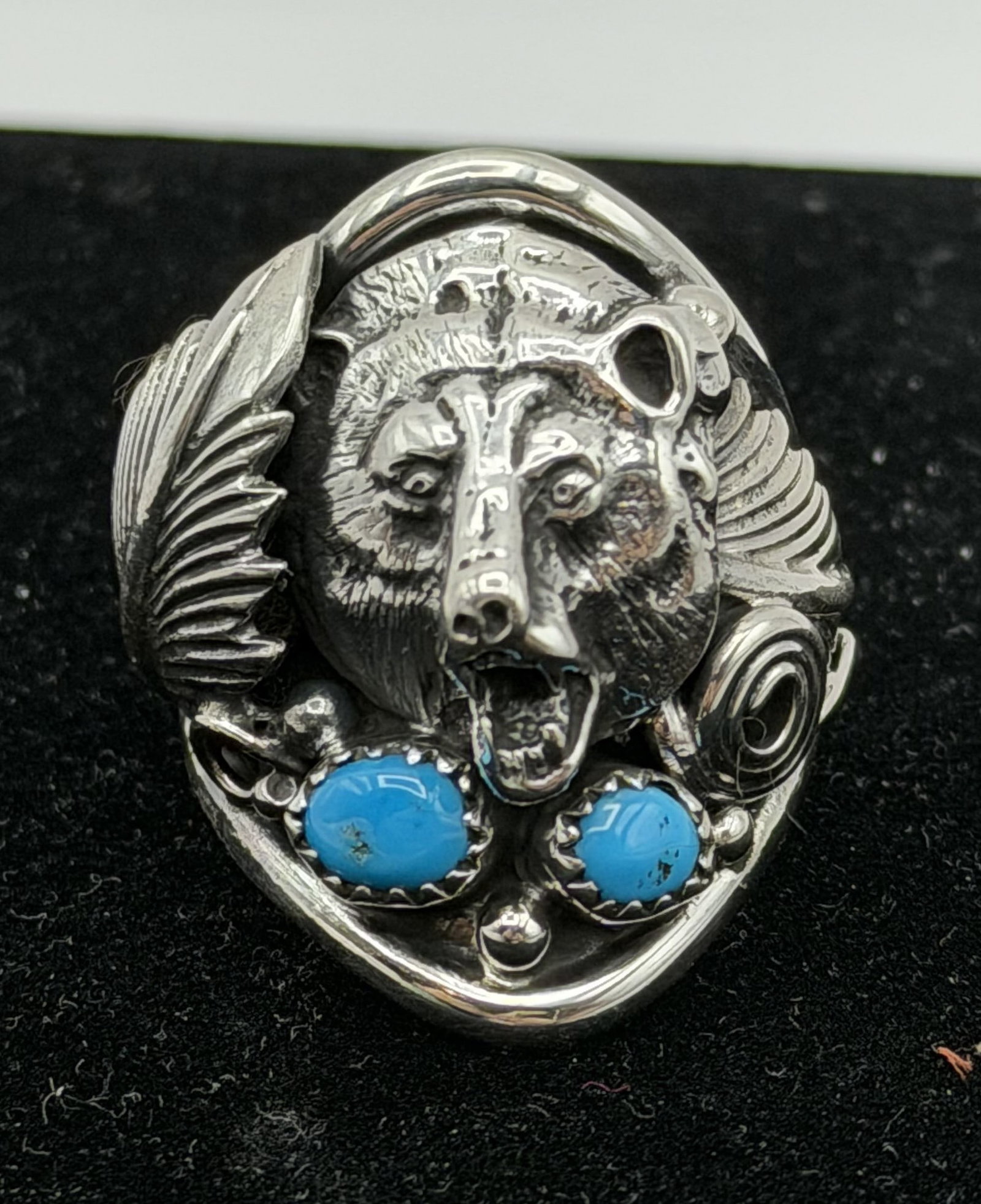 DARRELL MORGAN NAVAJO STERLING BEAR TURQUOISE RING: NEW OLD STOCK NATIVE AMERICAN HANDMADE RING SIGNED "DM". MARKED TESTED STERLING SILVER. RING SIZE 12. WEIGHS 17 GRAMS. FACE OF RING IS 1-1/8" NORTH SOUTH. WITH IMPERIAL AUCTION THE COST FOR PACKING AN