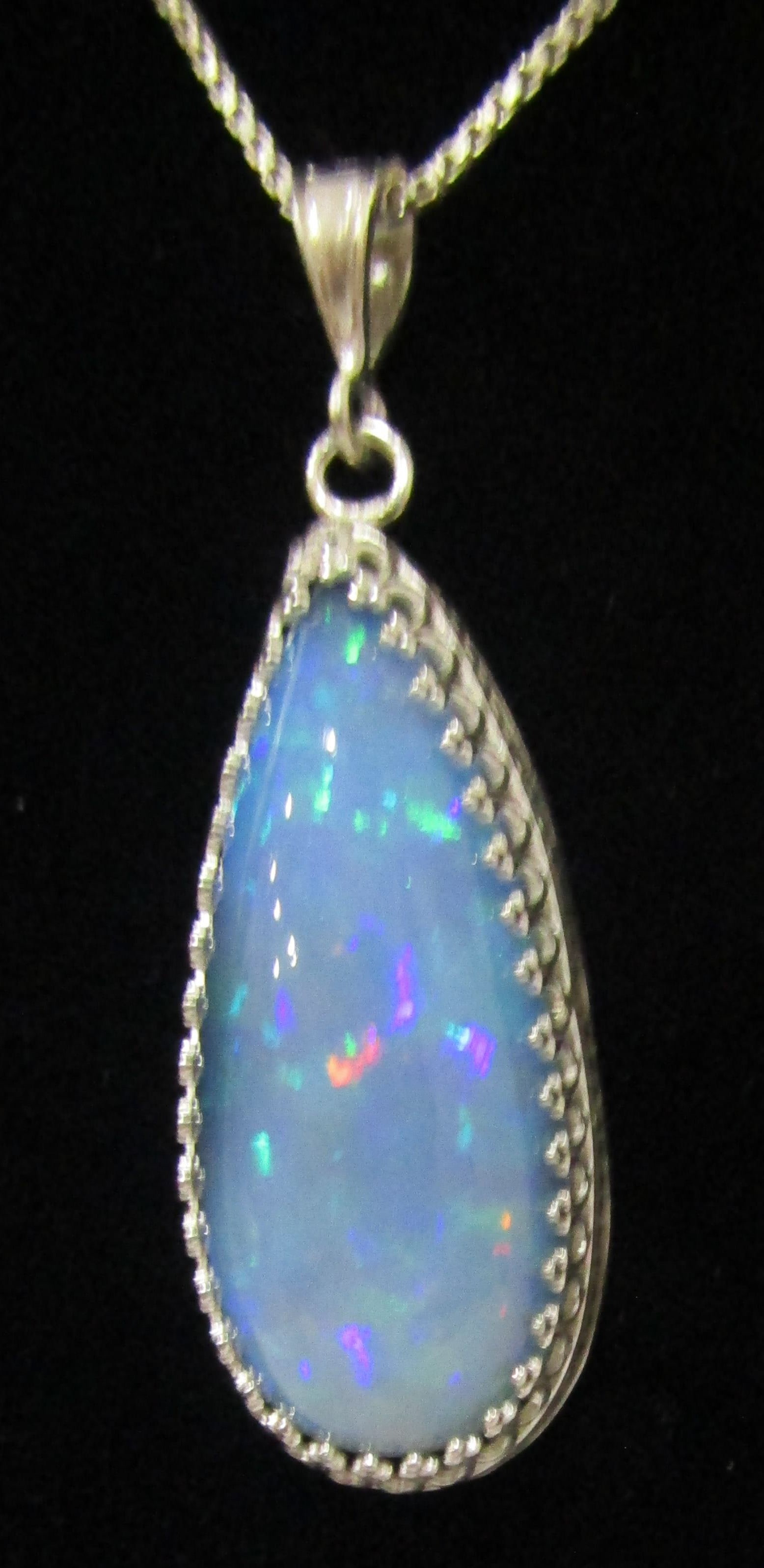 17CT BLUE FIRE OPAL 26" NECKLACE STERLING SILVER: 17 CARAT BLUE FIRE OPAL NECKLACE MEASURES 1 3/8 INCH LONG BY 5/8 INCH WIDE ON A 26 INCH LONG BOX CHAIN NECKLACE.. MARKED & TESTED STERLING SILVER. WEIGHS 13.0GRAMS. EXCELLENT CONDITION. WITH IMPERIAL 
