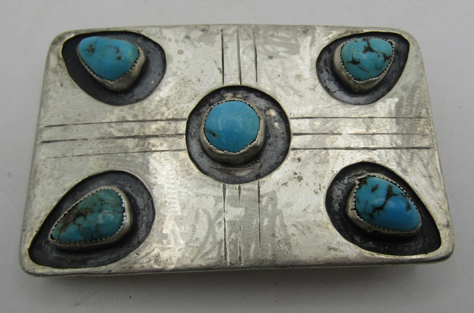 "JM" TURQUOISE BELT BUCKLE STERLING SILVER 53.6GRM: ARTIST HALLMARKED "JM" VINTAGE ESTATE GENUINE TURQUOISE BELT BUCKLE. NATIVE AMERICAN SOUTHWEST NAVAJO INDIAN JEWELRY. MEASURES 3 INCHES BY 2 INCHES. TESTED STERLING SILVER. WEIGHS 53.6GRAMS. EXCELLENT