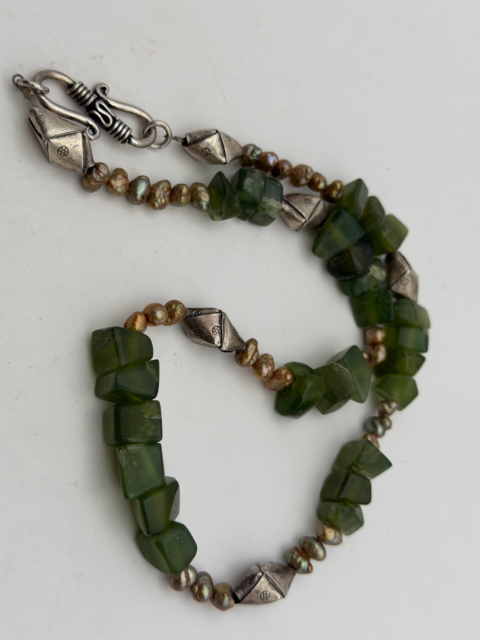 STERLING NEPHRITE JADE PEARL HILL TRIBE NECKLACE: UNIQUE FOLDED WOVEN STERLING BEADS AND DARK NEPHRITE GREEN JADE. BEADS ARE FROM THAILAND'S HILL TRIBE CRAFTSMEN. TESTED STERLING SILVER. MEASURES 19". WIDTH IS 1/2" WIDEST BEADS. WEIGHS 57.5 GRAMS. WI