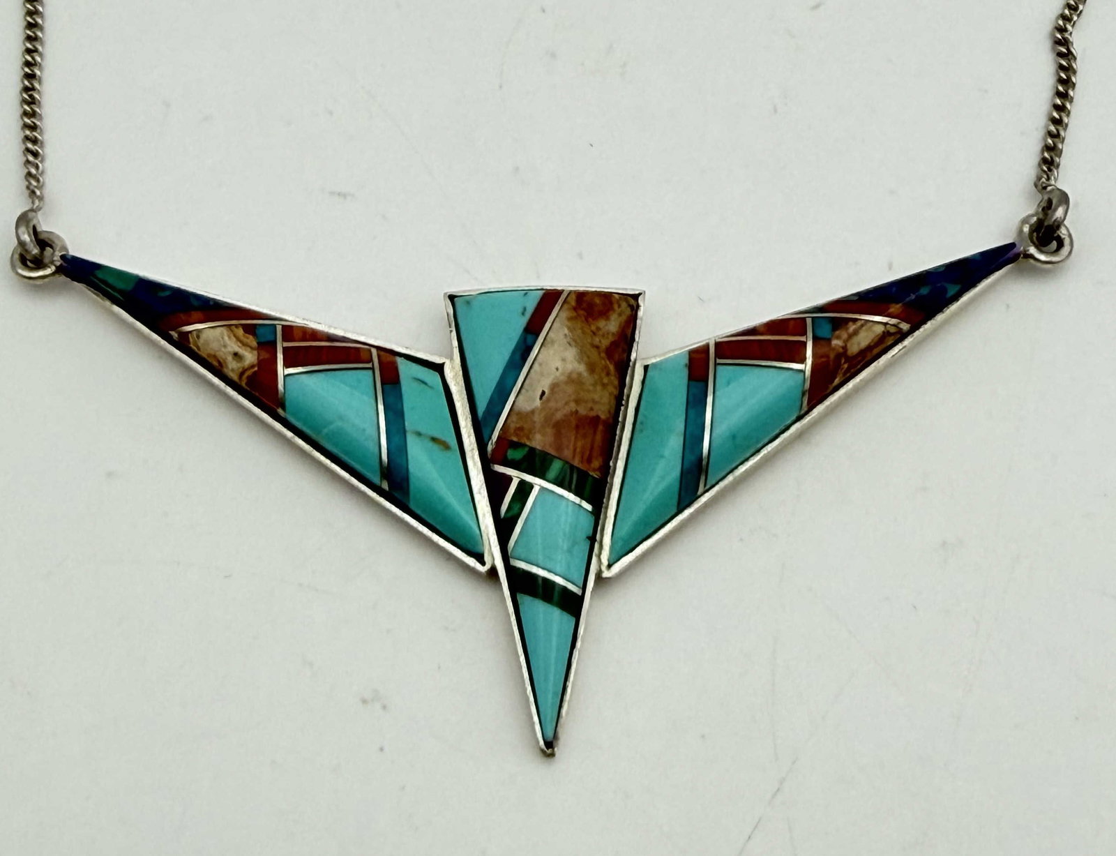 "P" STERLING TURQUOISE INLAID NECKLACE: SOUTHWESTERN TURQUOISE SHELL AGATE AND MALACHITE PENDANT NECKLACE. SIGNED "P" TESTED STERLING SILVER. WEIGHS 6.2 GRAMS. PENDANT IS 2.25" X 1". NECKLACE IS 17". WITH IMPERIAL AUCTION THE COST FOR PACKI