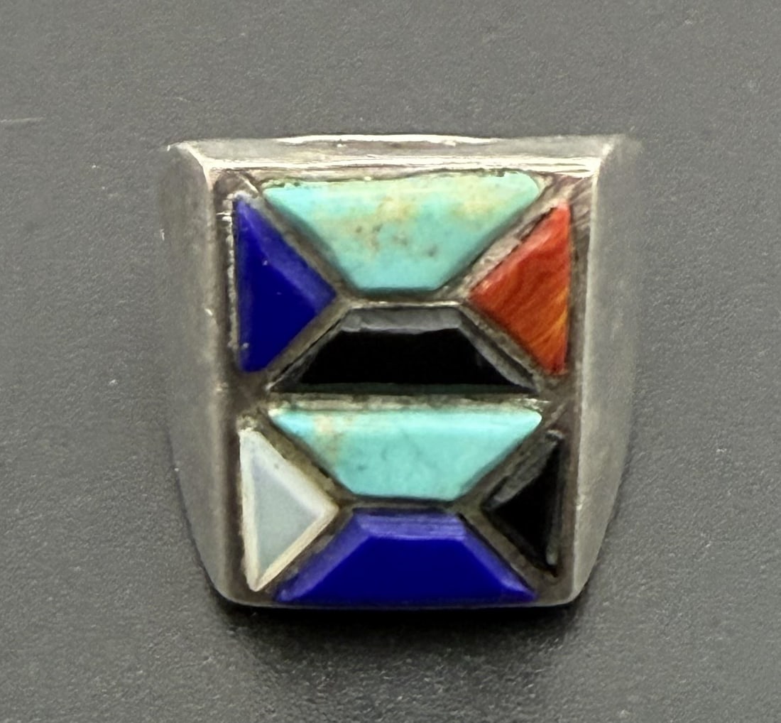 18 GRAM INLAID TURQUOISE STERLING RING GEOMETRIC: NATIVE AMERICAN HANDMADE SOUTHWESTERN RING. UNIQUE TRAPEZOIDAL GEOMETRIC DESIGN WITH LAPIS ONYX TURQUOISE AND MOTHER OF PEARL SHELL. UNSIGNED UNMARKED TESTED STERLING SILVER. FACE OF RING IS 3/4" HEIG