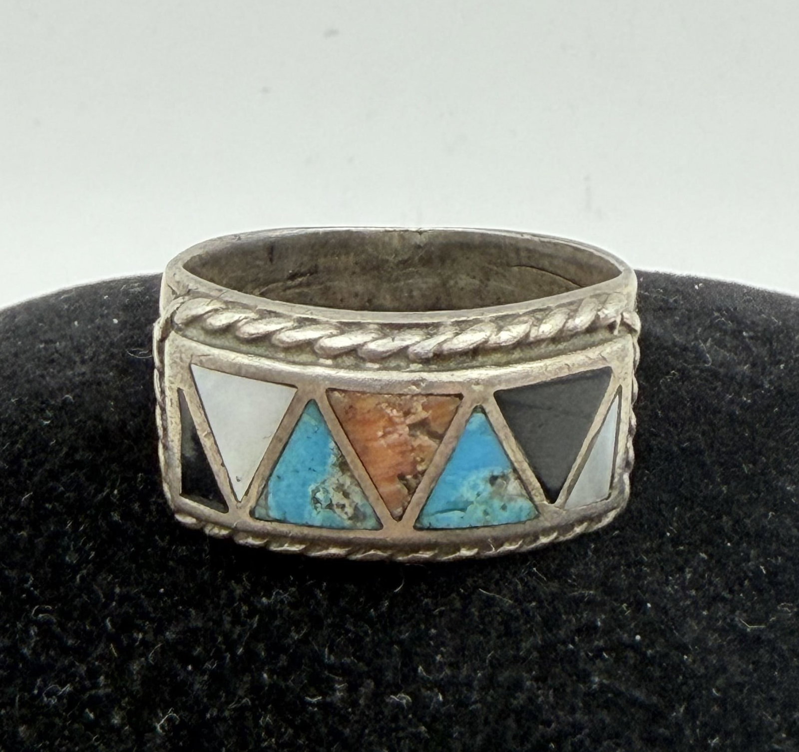 VTG TURQUOISE RED CORAL STERLING CIGAR BAND RING: VINTAGE NATIVE AMERICAN HANDMADE RING. MOTHER OF PEARL SHELL ONYX, TURQUOISE AND RED CORAL STONES. MARKED TESTED STERLING SILVER. MEASURES 1/2" TALL. WEIGHS 9.5 GRAMS. RING SIZE 10.5. WITH IMPERIAL AU
