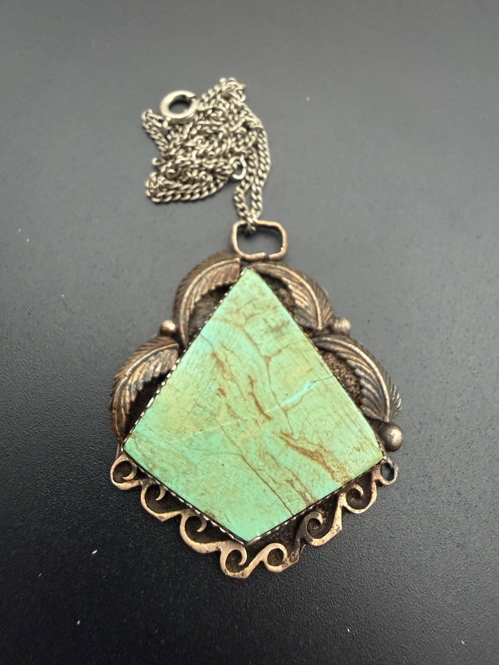 ROGER A LEWIS NAVAJO STERLING TURQUOISE NECKLACE: NATIVE AMERICAN HANDMADE SOUTHWESTERN PENDANT NECKLACE. SIGNED "RA LEWIS" TESTED STERLING SILVER. WEIGHS 18 GRAMS TOTAL. PENDANT IS 2" TALL X 1.75" WIDE. CHAIN IS 24". TURQUOISE STONE HAS HARD TO SEE 