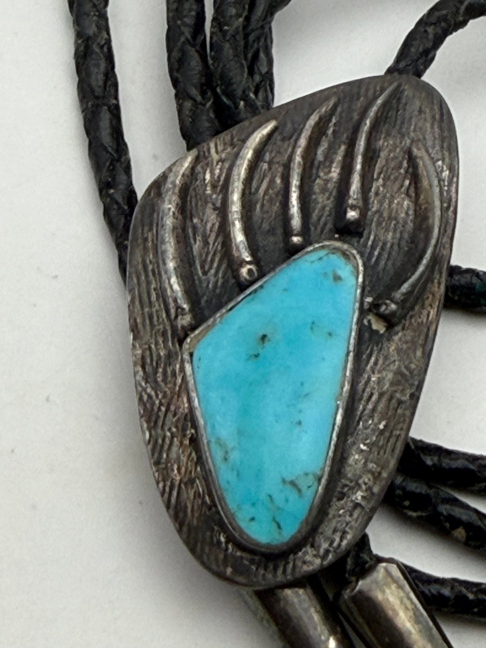 OLD PAWN BEAR PAW STERLING TURQUOISE BOLO TIE: VINTAGE NATIVE AMERICAN HANDMADE BOLO TIE NECKLACE. UNSIGNED TESTED STERLING SILVER. PENDANT MEASURES 2" X 1". LEATHER CORD IS 40" WITH STERLING ENDS. WEIGHS 34.5 GRAMS TOTAL WITH LEATHER. WITH IMPERI