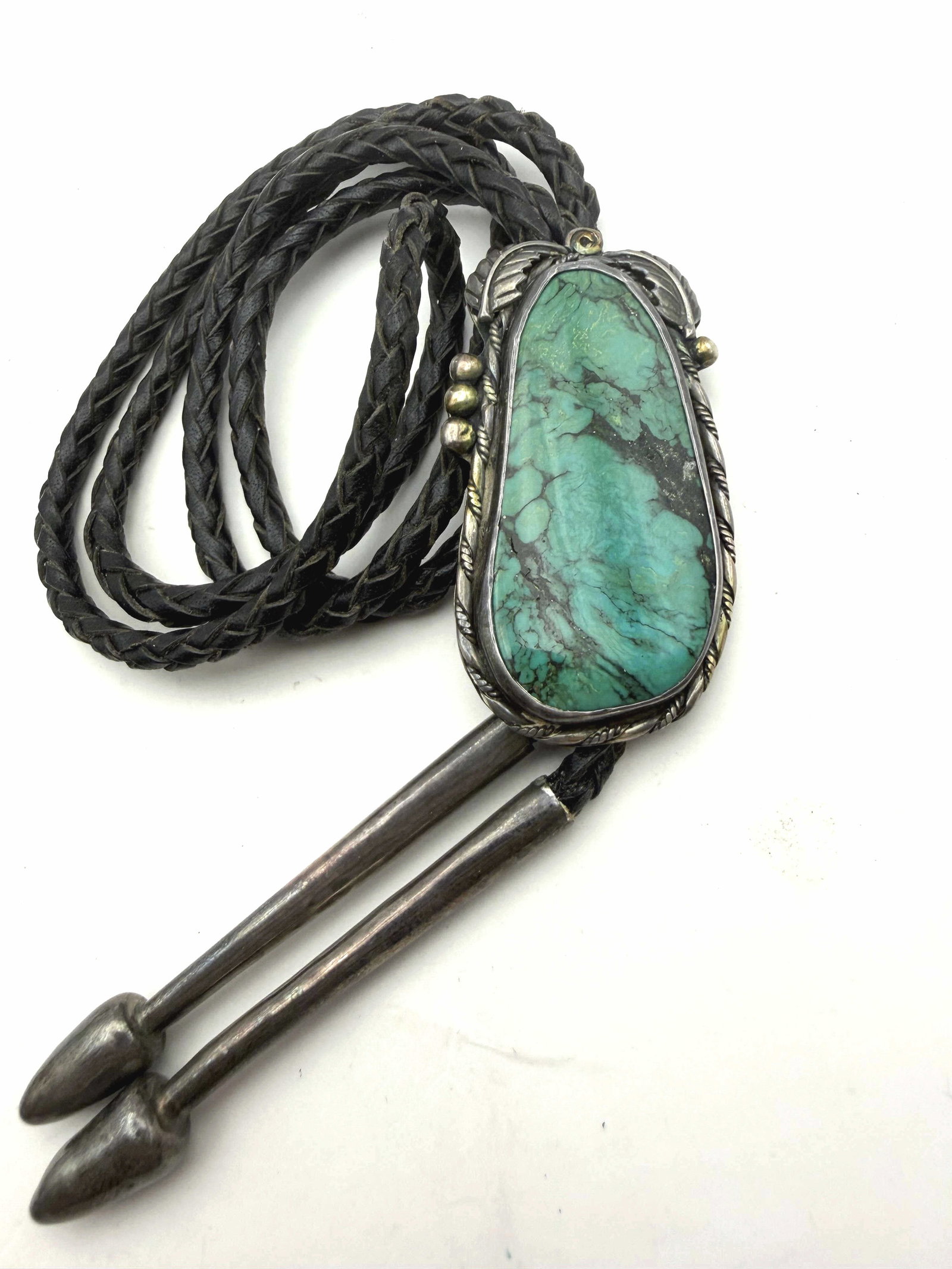 OLD PAWN STERLING TURQUOISE BOLO TIE NECKLACE: VINTAGE 1960'S-1970'S NATIVE AMERICAN HANDMADE BOLO TIE NECKLACE. UNSIGNED TESTED STERLING SILVER. UNIQUE OLD BOLO MECHANISM ON BACK. PENDANT MEASURES 2-3/8" X 1-3/8". LEATHER CORD IS 41" WITH UNIQUE 