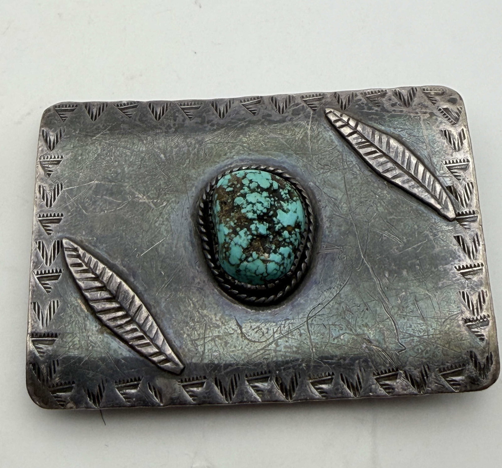 SONNY SPRUCE TAOS STERLING TURQUOISE BELT BUCKLE: 1970'S OLD PAWN VINTAGE NATIVE AMERICAN HANDMADE BELT BUCKLE SIGNED "SONNY SPRUCE TAOS PUEBLO NM". TESTED STERLING SILVER. MEASURES 3" X 2" AND FITS 1.5" LEATHER. WEIGHS 69 GRAMS. WITH IMPERIAL AUCTIO