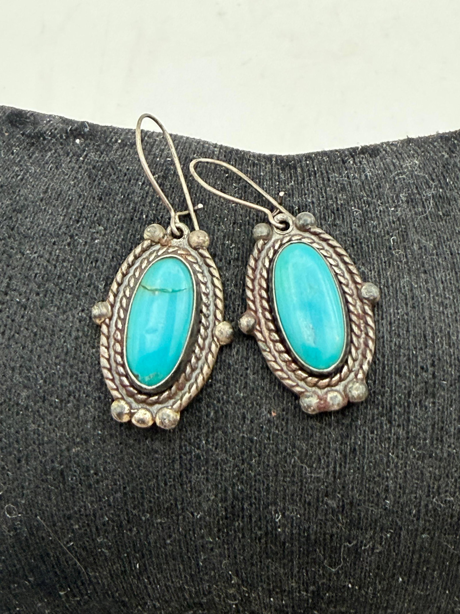FRED HARVEY STERLING TURQUOISE EARRINGS: VINTAGE HANDMADE NATIVE AMERICAN EARRINGS. ONE CRACKED STONE. UNSIGNED MARKED TESTED STERLING SILVER. WEIGHS 6.5 GRAMS. MEASURES 7/8" WITHOUT DROP. WITH IMPERIAL AUCTION THE COST FOR PACKING AND SHIPP