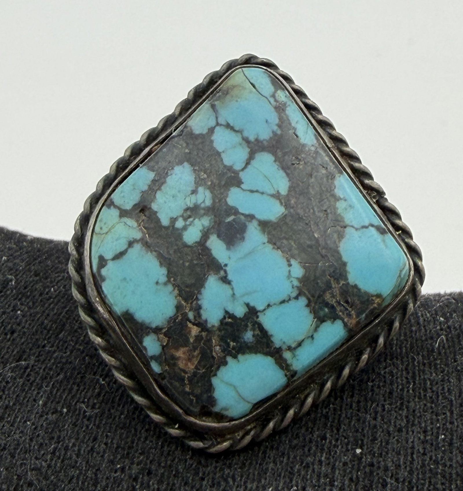 VINTAGE STERLING TURQUOISE NATIVE AMERICAN RING: OLD PAWN NATIVE AMERICAN HANDMADE RING. UNMARKED UNSIGNED TESTED STERLING SILVER. FACE OF RING IS 1-1/8". RING SIZE 6. WEIGHS 7 GRAMS. WITH IMPERIAL AUCTION THE COST FOR PACKING AND SHIPPING VIA USPS 