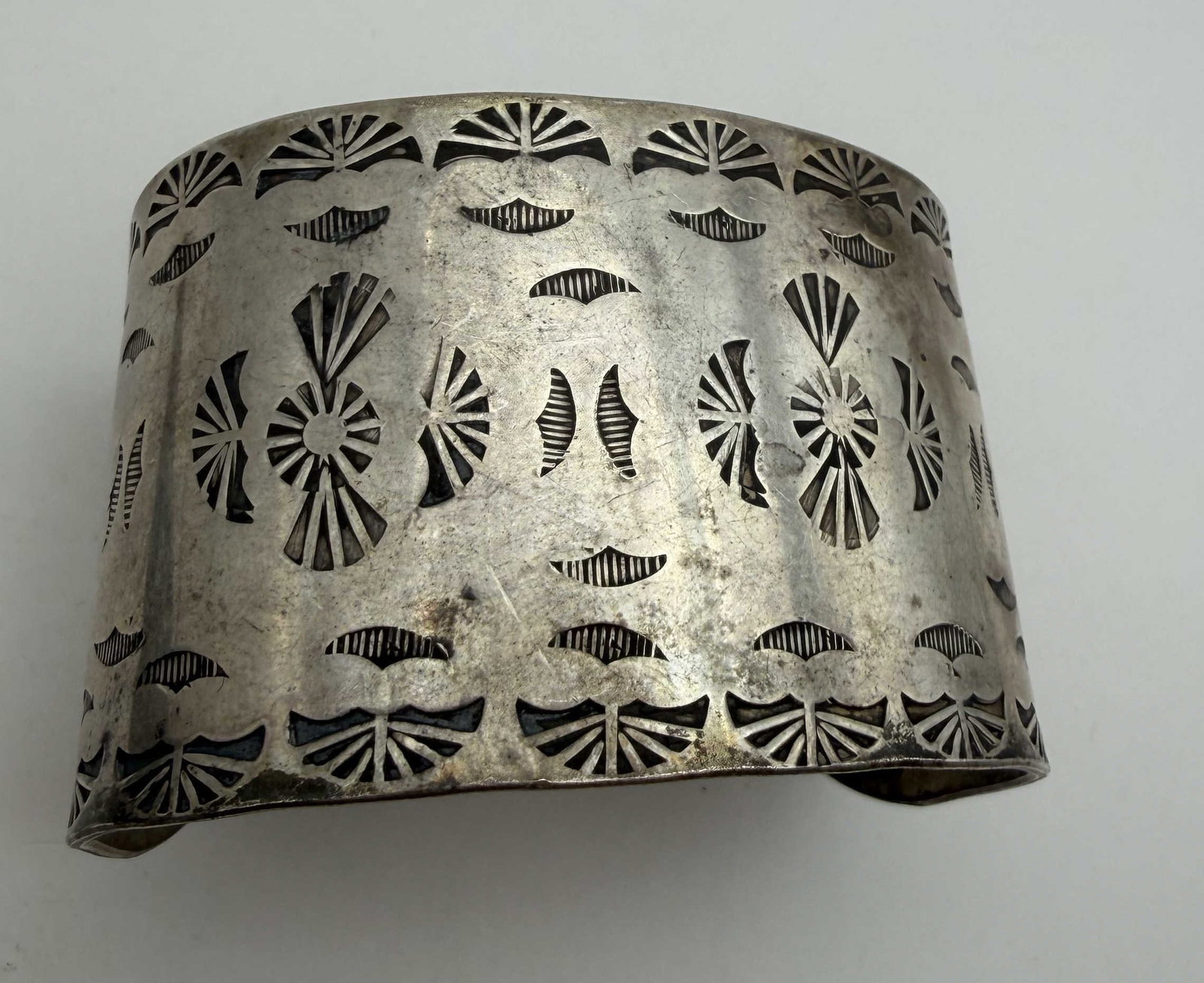 STAMPWORK HOPI STERLING CUFF BRACELET: NATIVE AMERICAN HANDMADE STAMPWORK BRACELET. SIGNED WITH HOPI BIRD SUN HALLMARK UNKNOWN. TESTED STERLING SILVER. FACE IS 1.5" TALL. GAP IS 1.25" AND FITS 6.5" WRIST. WEIGHS 64.6 GRAMS. WITH IMPERIAL A