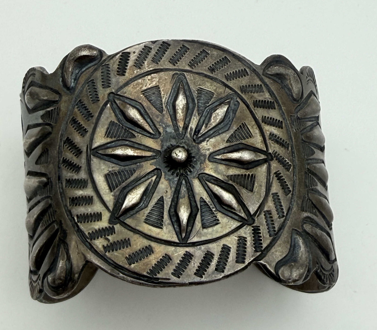 104 GRAM STERLING CONCHO CUFF BRACELET: NATIVE AMERICAN HANDMADE CONCHO CUFF BRACELET. SIGNED "2R" TESTED STERLING SILVER. FACE IS 1.75" TALL. GAP IS 1.25" AND FITS 7.5" WRIST. WEIGHS 104 GRAMS. WITH IMPERIAL AUCTION THE COST FOR PACKING AN