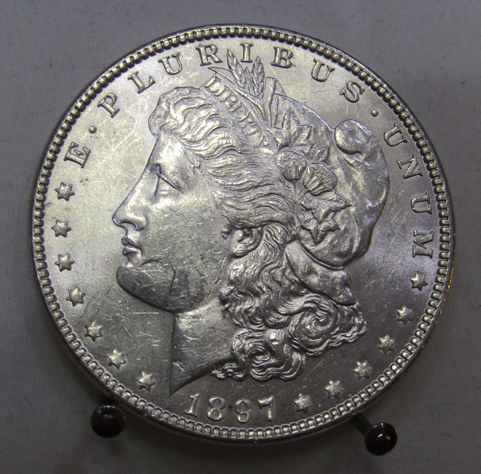 1897 MORGAN US SILVER DOLLAR UNCIRCULATED COIN: 1897 MORGAN SILVER DOLLAR UNC. WITH IMPERIAL AUCTION THE COST FOR PACKING AND SHIPPING VIA USPS IN THE USA IS $5.