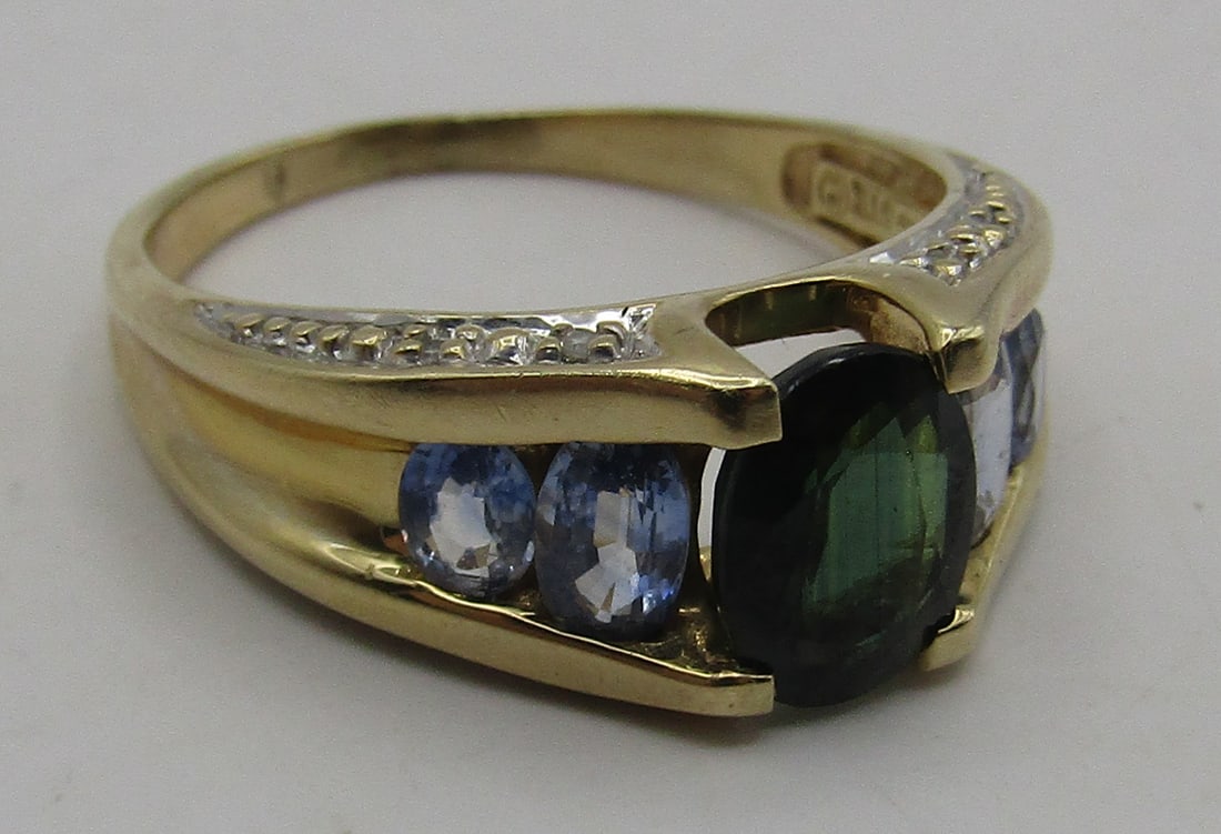 14K GOLD DIAMOND SAPPHIRE RING 4.8GR SIZE 8.5: SIZE 8.5. GENUINE VINTAGE ESTATE 8 DIAMOND,1 CARAT OVAL GREEN & 4 1CT TW BLUE SAPPHIRE GEMSTONE RING MARKED "585 GTR" YELLOW GOLD. WEIGHS 4.8 GRAMS. EXCELLENT CONDITION. WITH IMPERIAL AUCTION THE COST