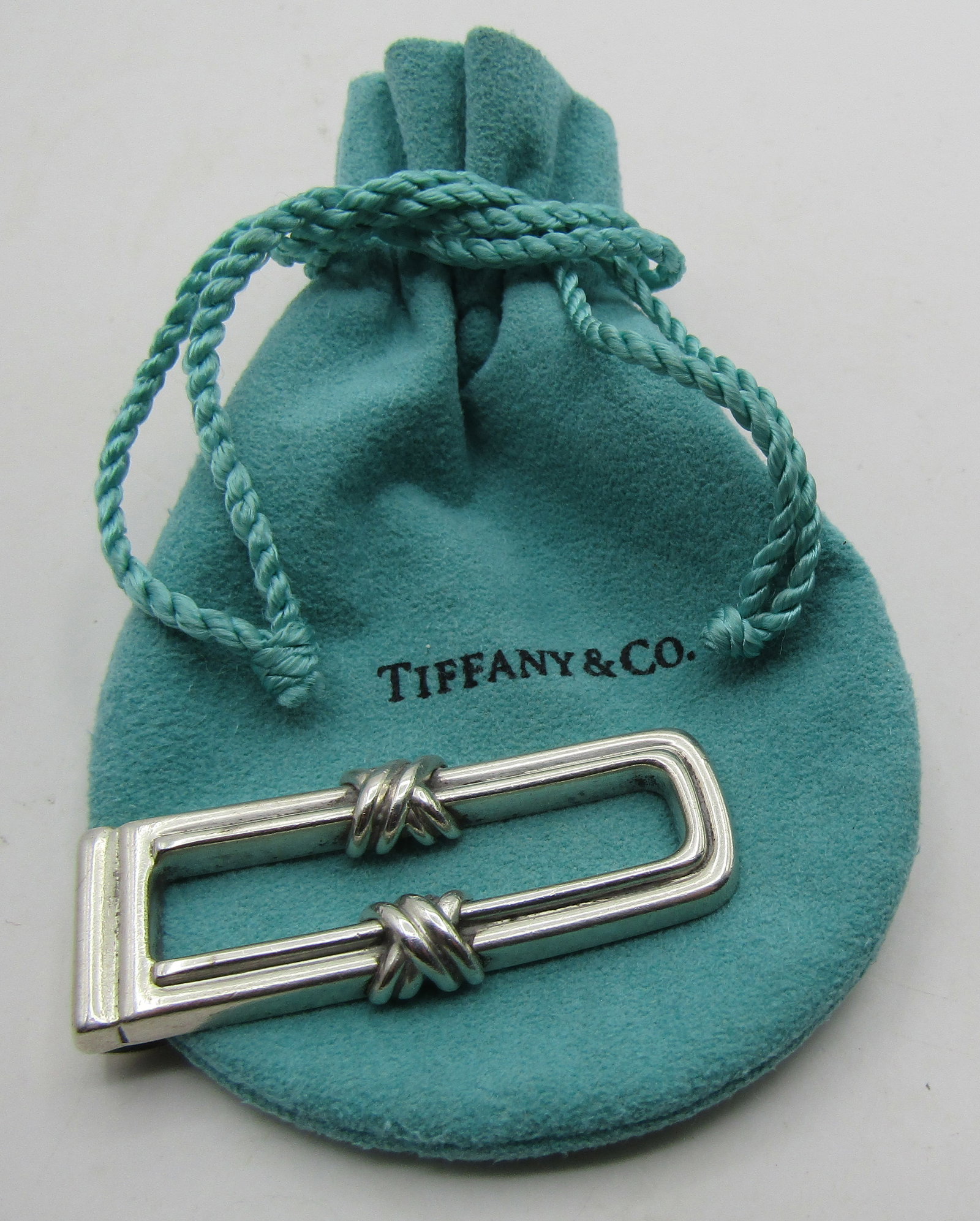 TIFFANY & CO MONEY CLIP STERLING SILVER 1992 18.6G: GENUINE SIGNED "TIFFANY & CO. 1992 925" WITH POUCH. MEASURES 2 INCHES LONG. WEIGHS 18.6 GRAMS STERLING SILVER. EXCELLENT USED CONDITION. WITH IMPERIAL AUCTION THE COST FOR PACKING AND SHIPPING VIA USP