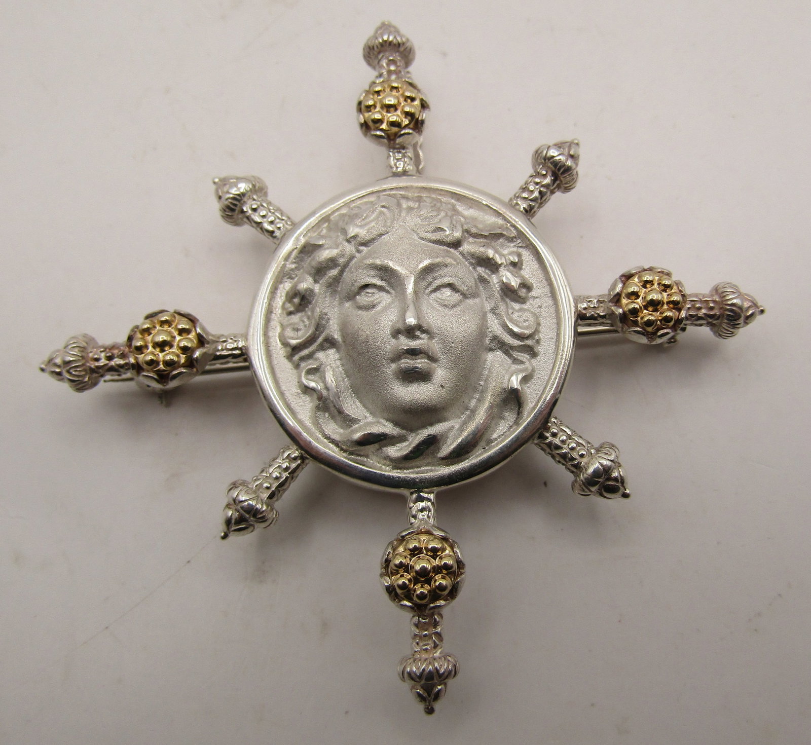 TAGLIAMONTE 14K GOLD STERLING MEDUSA PENDANT & PIN: DESIGNER SIGNED "TAGLIAMONTE ITALY 925 14K" NECKLACE PENDANT AND BROOCH MEASURES 2 3/8" BY 2 3/8". WEIGHS 25.3 GRAMS. EXCELLENT, LIKE NEW CONDITION. WITH IMPERIAL AUCTION THE COST FOR PACKING AND SHIP