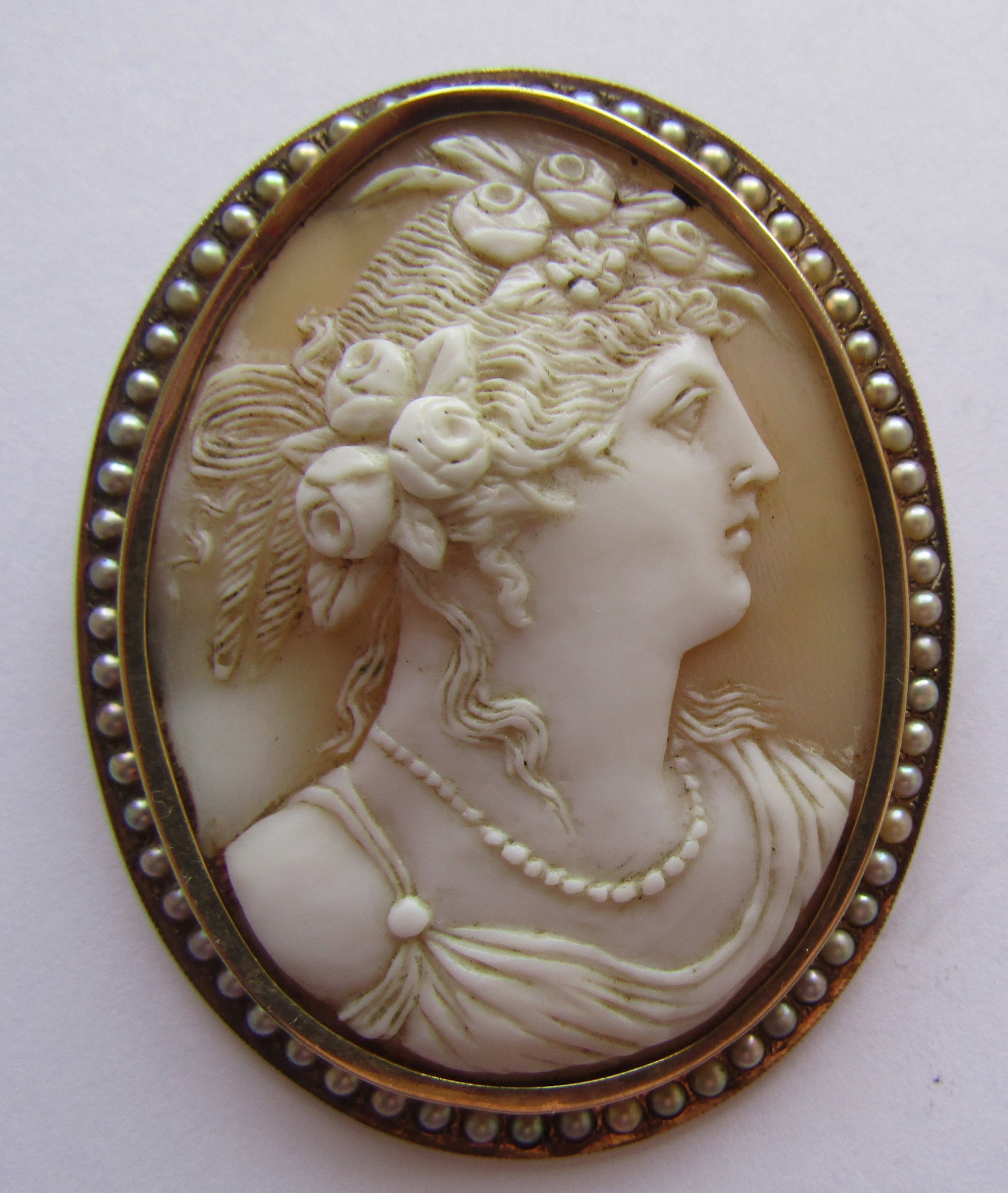 14K GOLD CAMEO 2.25" PIN PENDANT SEED PEARL 17GRAM: LARGE ANTIQUE VINTAGE ESTATE ORNATELY CARVED SHELL CAMEO MEASURES 2.25 INCHES BY 1.75 INCHES. FRAME TESTED 14K YELLOW GOLD WITH 60+ NATURAL SEED PEARLS; PIN WAS REPLACED AT SOME POINT IS 10K YELLOW GO