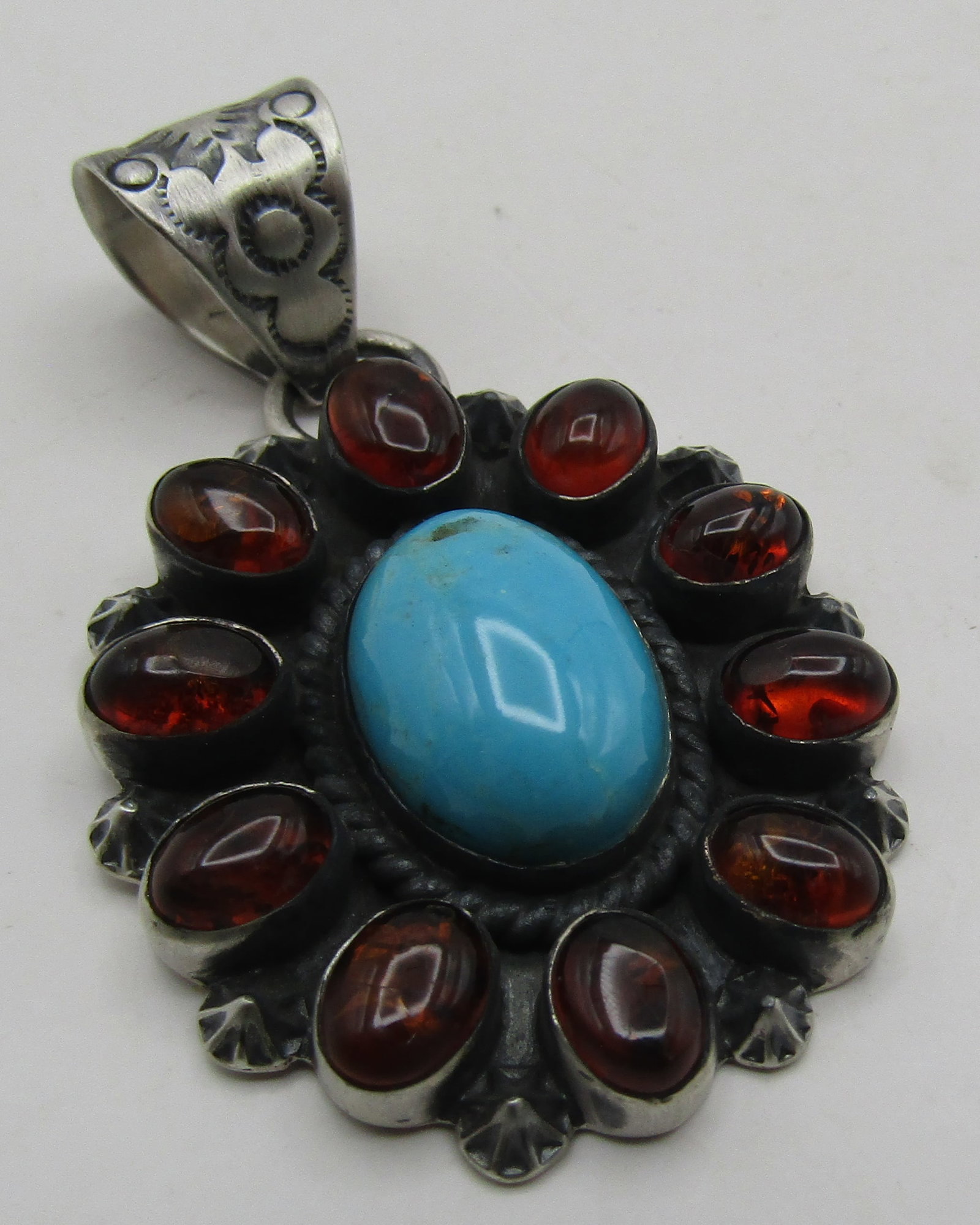 NAVAJO AMBER TURQUOISE PENDANT STERLING SILVER: VINTAGE ESTATE ARTIST HALLMARKED & "STERLING". GENUINE 10 AMBER,TURQUOISE & STERLING SILVER PENDANT. NATIVE AMERICAN SOUTHWEST NAVAJO INDIAN JEWELRY. MEASURES 2.5 INCHES BY 1.5 INCHES. WEIGHS 20.5 GRA