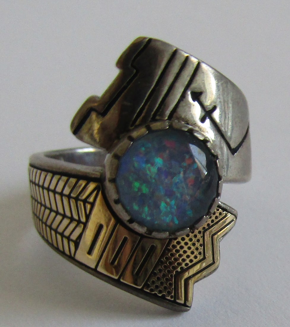 "TENORIO" OPAL RING 14K & STERING SILVER 8GR SIZE?: RODERICK TENORIO, NATIVE SANTO DOMINGO ARTIST,OPAL RING. TOP MEASURES 1 INCH WIDE. MARKED "RMT, CR, 14K, 925", WEIGHS 8.3 GRAMS. SIZE ???. EXCELLENT USED CONDITION. WITH IMPERIAL AUCTION THE COST FOR 