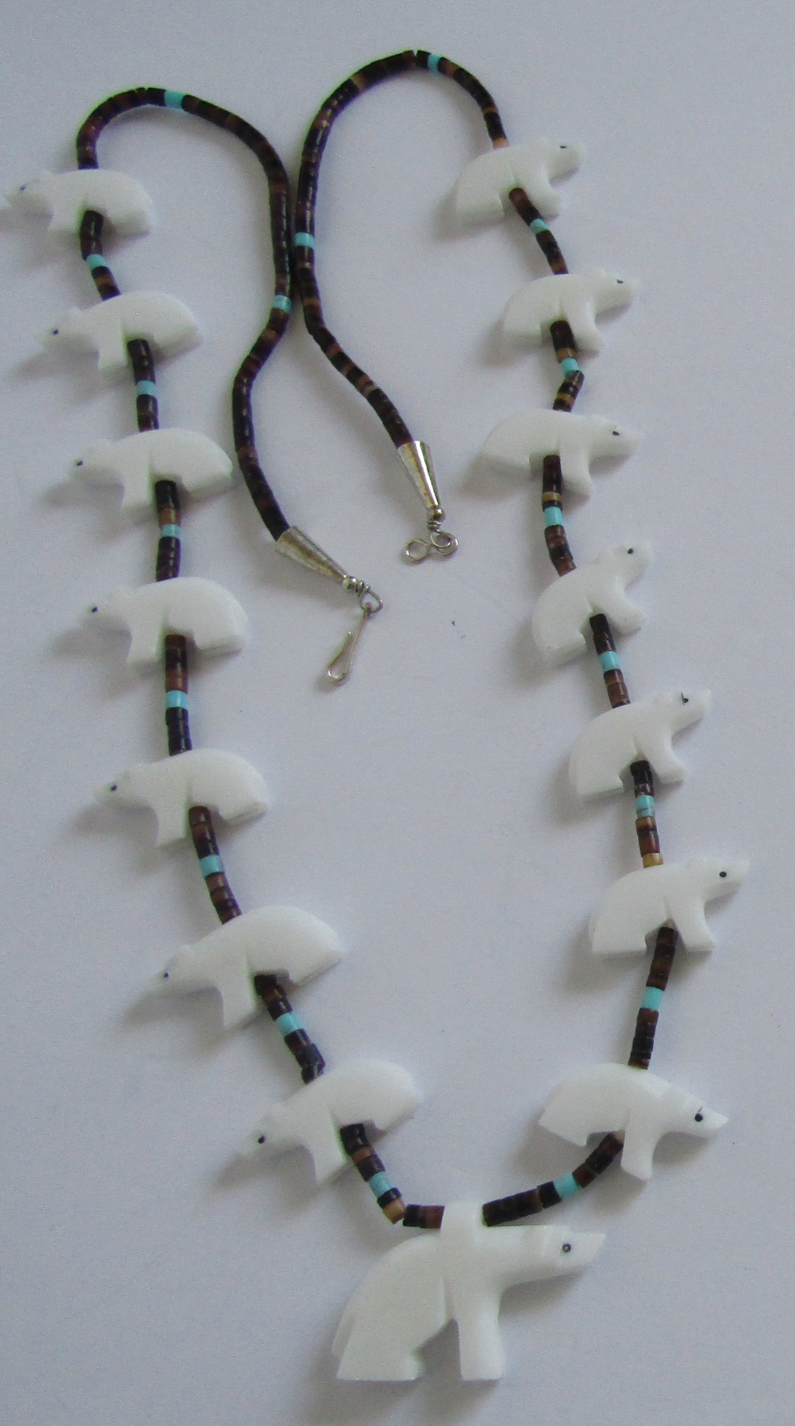 CARVED STONE BEAR FETISH NECKLACE TURQUOISE HEISHI: 15 CARVED WHITE STONE BEARS ON A 29 INCH LONG STRAND OF HEISHI AND TURQUOISE BEADS. THE CENTER BEAR MEASURES 38MM BY 25MM. WEIGHS 61 GRAMS. EXCELLENT CONDITION. WITH IMPERIAL AUCTION THE COST FOR PACK