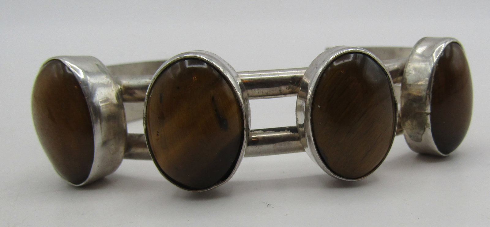 "MS" TIGER EYE CUFF BRACELET STERLING SILVER 36GRM: VINTAGE ESTATE ARTIST HALLMARKED "MS STERLING" TESTED STERLING SILVER BRACELET. NATIVE AMERICAN SOUTHWEST NAVAJO INDIAN JEWELRY. TOP MEASURES .75 INCHES WIDE. FITS A 7.5 INCH WRIST WITH A 30MM GAP. WE
