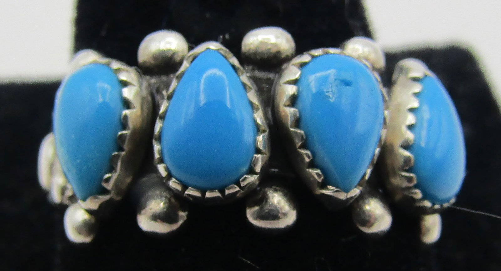 WHEELER TURQUOISE RING STERLING SILVER: VINTAGE ESTATE GENUINE TURQUOISE RING HALLMARKED FOR "WHEELER". NATIVE AMERICAN SOUTHWEST NAVAJO INDIAN JEWELRY. MEASURES .75 INCH ACROSS. TESTED AND MARKED STERLING SILVER. SIZE 7. WEIGHS 4.3 GRAMS. 