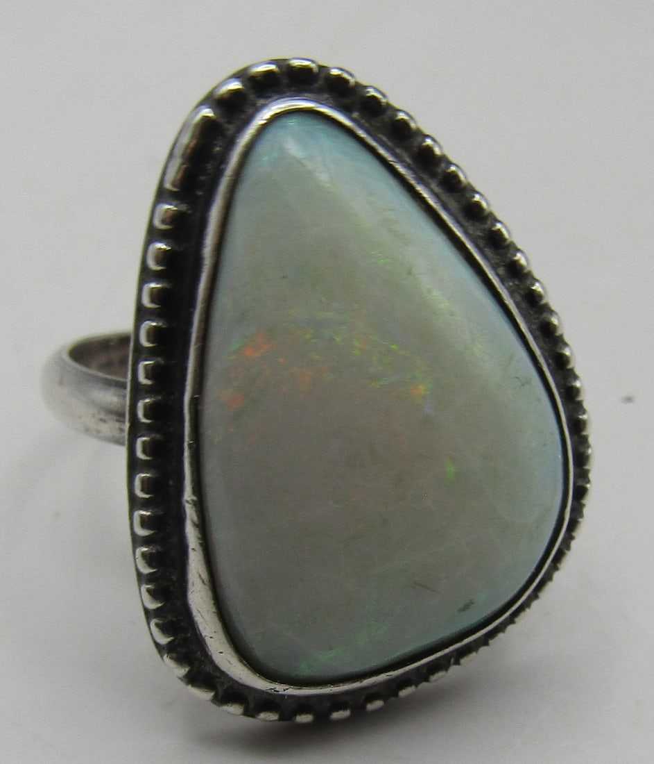 7CT FIRE OPAL RING STERLING SILVER SIZE 8.5: 7 CARAT FIRE OPAL RING TESTED STERLING SILVER. SIZE 8 1/2. WEIGHS 7.2 GRAMS. EXCELLENT USED CONDITION. WITH IMPERIAL AUCTION THE COST FOR PACKING AND SHIPPING VIA USPS IN THE USA IS $5.