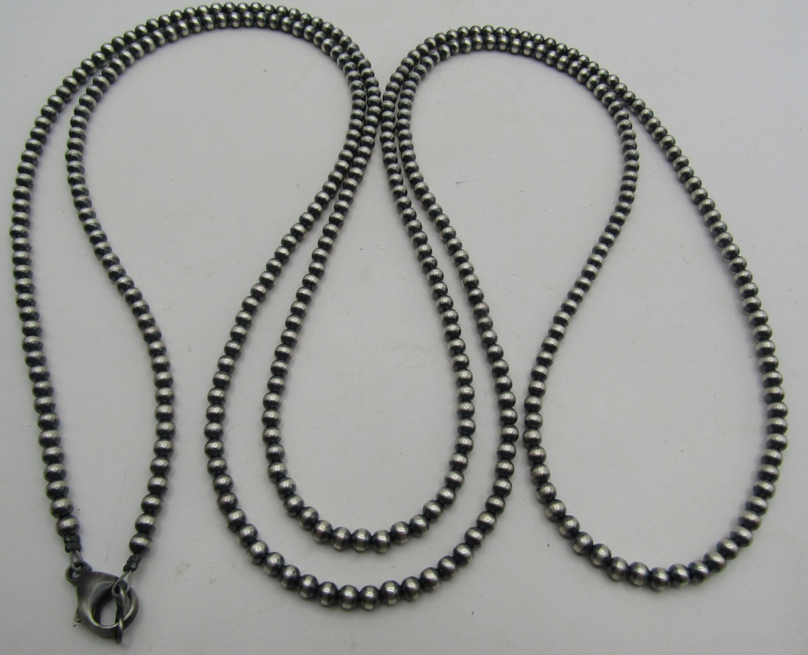 60"NAVAJO PEARL STERLING SILVER BEAD NECKLACE: 4MM BEAD NECKLACE TESTED STERLING SILVER NATIVE AMERICAN SOUTHWEST INDIAN NAVAJO JEWELRY. MEASURES 60 INCHES LONG. WEIGHS 37.1 GRAMS. EXCELLENT CONDITION. WITH IMPERIAL AUCTION THE COST FOR PACKING AN