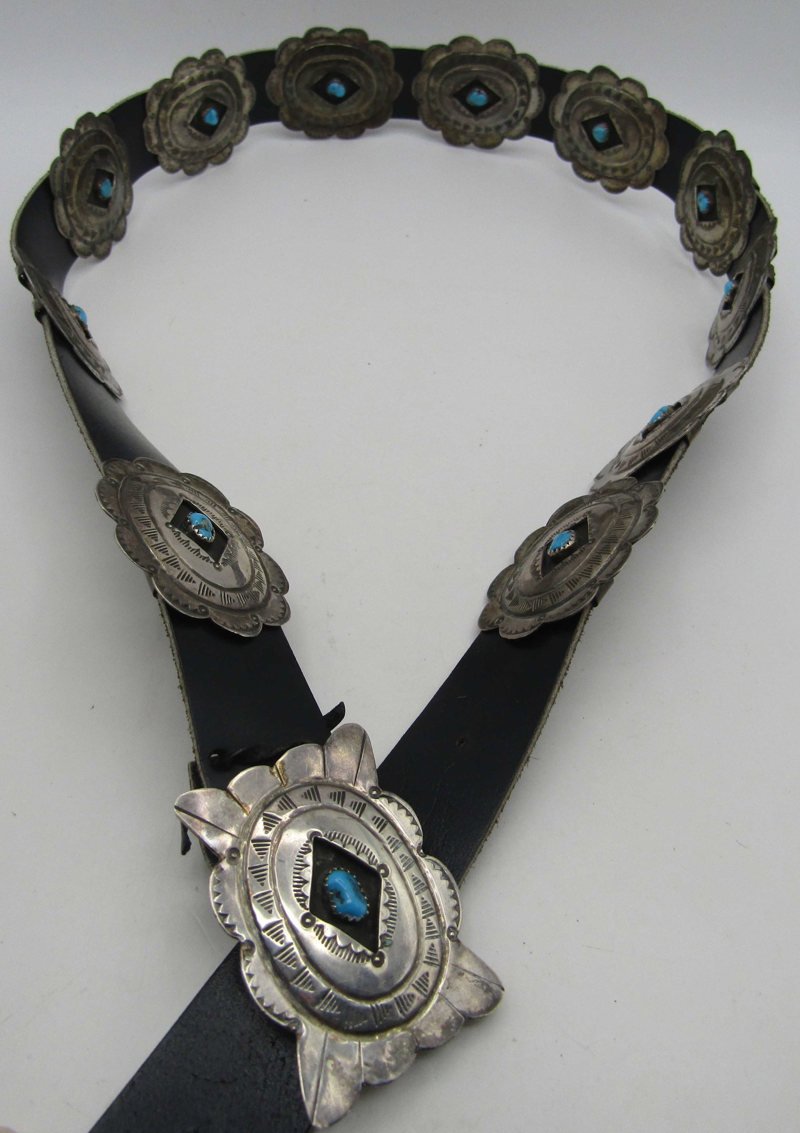 "FC" 11 TURQUOISE 43" CONCHO BELT STERLING SILVER: ARTIST SIGNED "FC STERLING" TURQUOISE STERLING SILVER CONCHO BELT. HANDMADE NATIVE AMERICAN SOUTHWEST NAVAJO INDIAN JEWELRY. MEASURES 43 INCHES LONG. WITH A 2 INCHES BY 1.50 INCH CONCHOS. COPPER BACK 