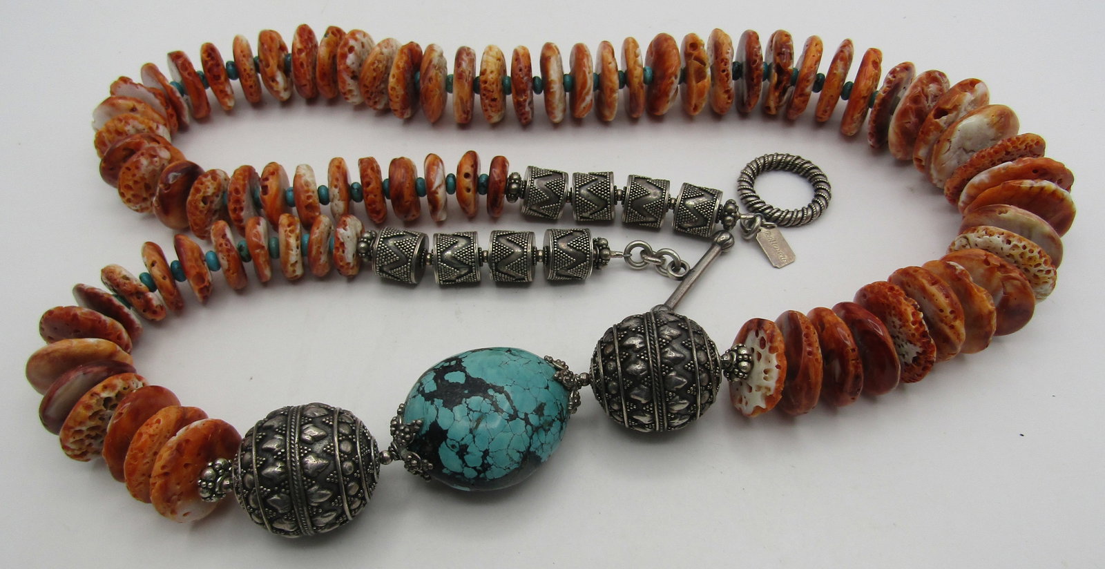 34" SPINY OYSTER TURQUOISE STERLING NECKLACE 333GR: HUGE ARTIST SIGNED "ROLLANDE" 34 INCH LONG STRAND OF SPINY OYSTER SHELL, TURQUOISE AND STERLING SILVER BEADS. GRADUATED FROM 13MM TO 30MM BEADS WITH GENUINE 4MM TURQUOISE SPACERS. WEIGHS 333.9 GRAMS. 