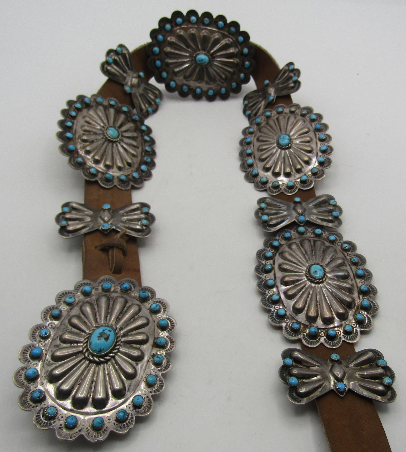 317GR BLACKGOAT TURQUOISE CONCHO BELT STERLING: ARTIST SIGNED "INDIO BLACKGOAT" CLUSTER TURQUOISE STERLING SILVER CONCHO BELT. HANDMADE NATIVE AMERICAN SOUTHWEST NAVAJO INDIAN JEWELRY. MEASURES 43 INCHES LONG. WITH A 3 INCH BY 2.25 INCH BUCKLE AND 