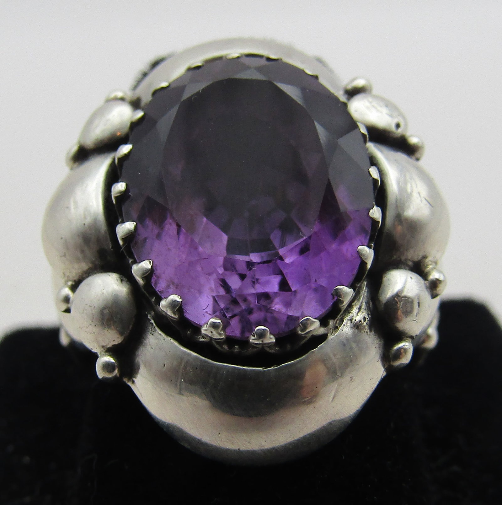 8CT CLEM NALWOOD AMETHYST RING STERLING SILVER: CLEM NELWOOD AMETHYST RING WITH AN 8 CARAT GENUINE AMETHYST STONE. ARTIST HALLMARKED "CN STERLING" NATIVE AMERICAN SOUTHWEST NAVAJO INDIAN JEWELRY. SIZE 7. MEASURES 1 INCH. WEIGHS 11.0 GRAMS. EXCELLEN
