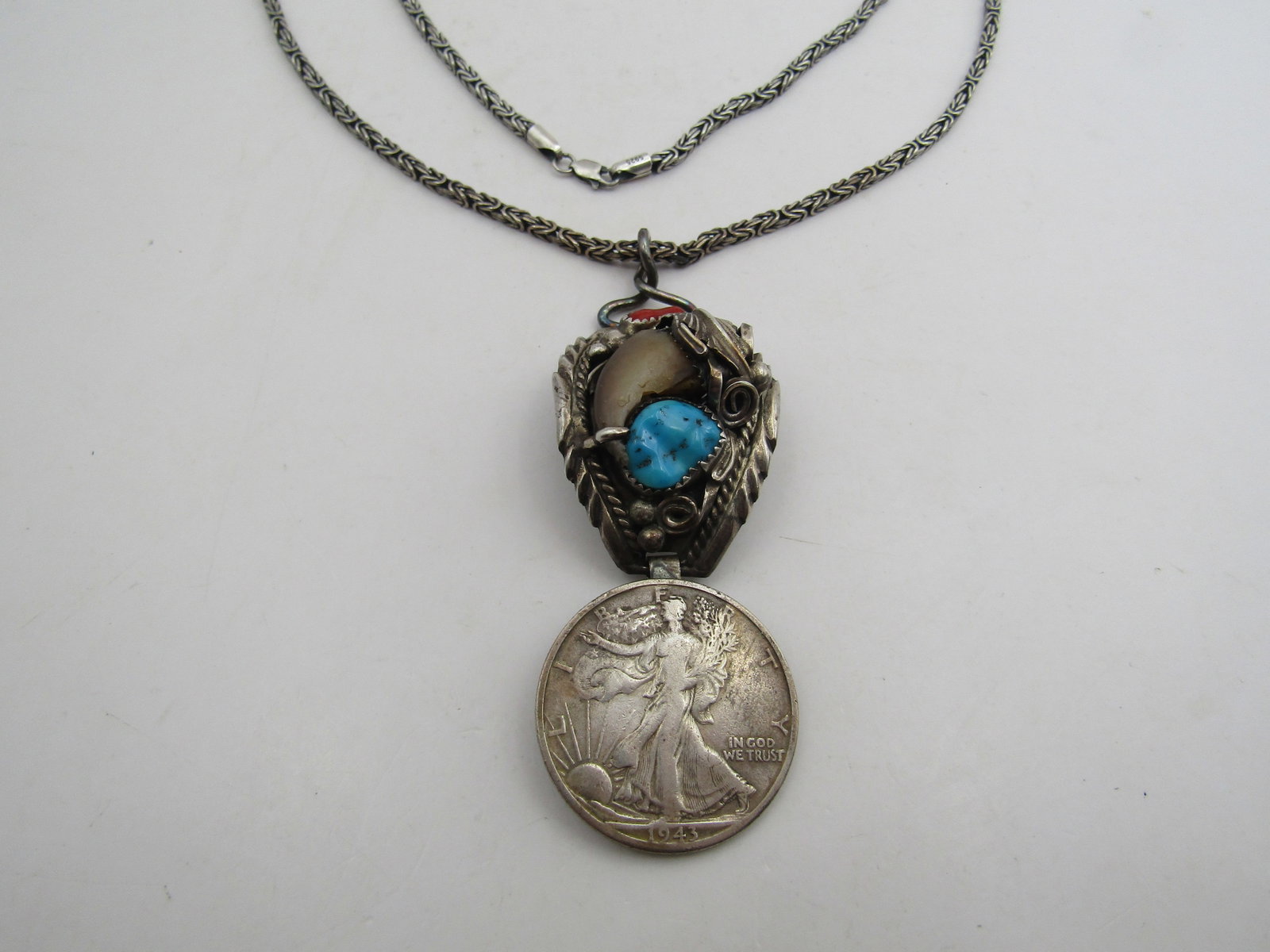 TURQUOISE BEAR CLAW COIN PENDANT & CHAIN: M THOMAS SIGNED BEAR CLAW PENDANT WITH 1943 STANDING LIBERTY SILVER HALF DOLLAR. 22 INCH STERLING LINK CHAIN. 3 INCH PENDANT. TURQUOISE AND CORAL NATIVE PENDANT. WEIGHS 47.5 GRAMS . USA SHIPPING $5.