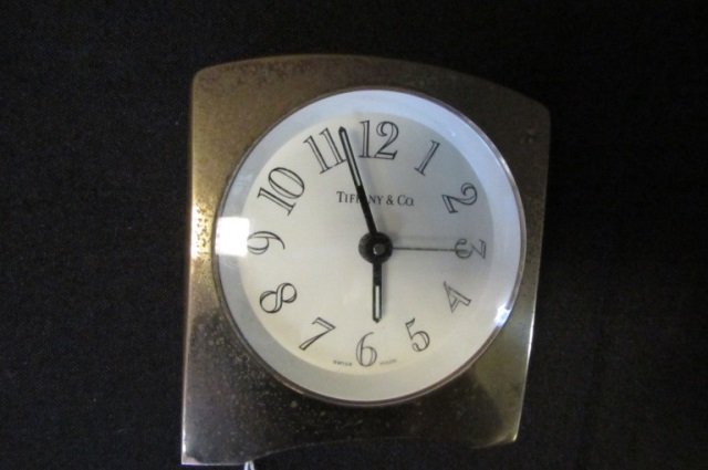 Tiffany & Co. Quartz Travel Clock in Brass Case: 3.312 Tiffany & Co. Quartz Travel Clock in Brass Case. Stands 2 3/4" x 2 1/2", Needs Battery