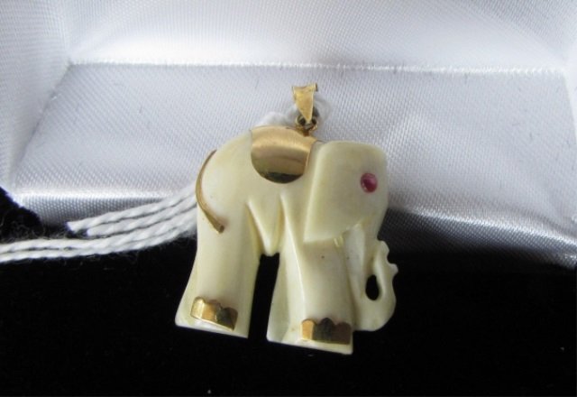 Ruby & Ivory Elephant 14k Gold Pendant: 3.635. Genuine carved ivory & solid 14k gold with ruby for an eye. Elephant is 3/4" tall and 1" to the top of the bail. Bail is marked "14k 585"
