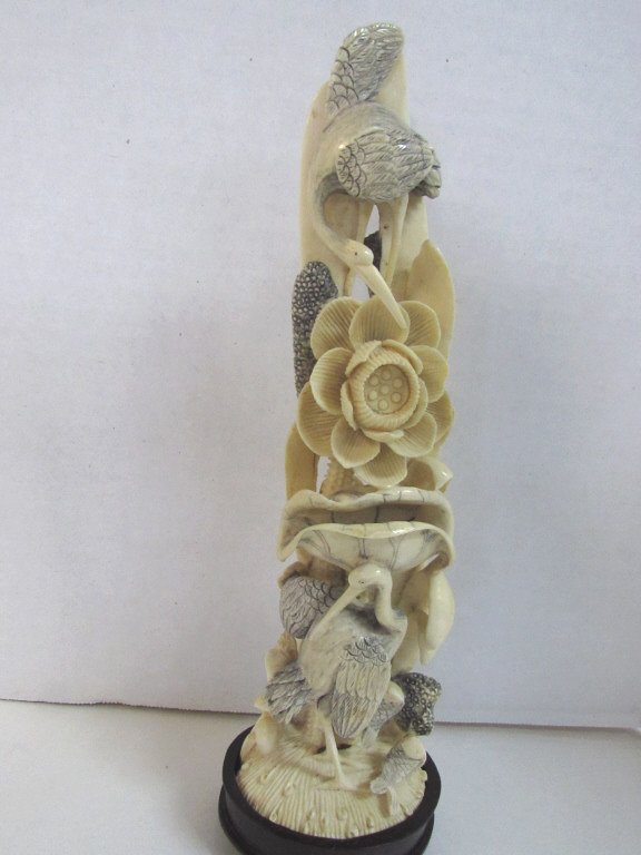 9" IVORY CRANES SCENE: 86.6B. PRE-1950's CARVED IVORY FLORAL SCENE HAS TWO CRANES BATHING AND HUNTING. 9" WITH BASE.