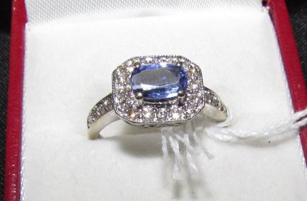 1ct Tanzanite & 0.5 ct Diamond 14k White Gold Ring: 3.884. Grogeous setting has a 1 ct natural tanzanite surrounded by .50 ctw diamonds in solid 14k white gold. Ring is size 7.75. Weighs 3.5 grams.