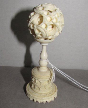 Ivory Dragon Puzzle Ball Pedestal Chinese Carving: 86.34 Antique Ivory Dragon Design Puzzle Ball with Pedestal. Measures 4 1/2 inches tall and 1 1/2 inches wide.