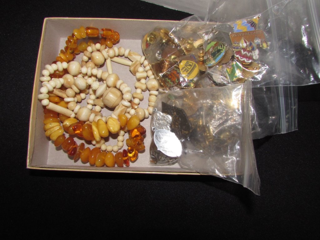 Amber & Ivory Bead Necklace & Balloon Pins: 136.9. Ivory or bone necklace 36". amber necklace 16". Over 100 collectible balloon pins and various catholic or religious pendants.