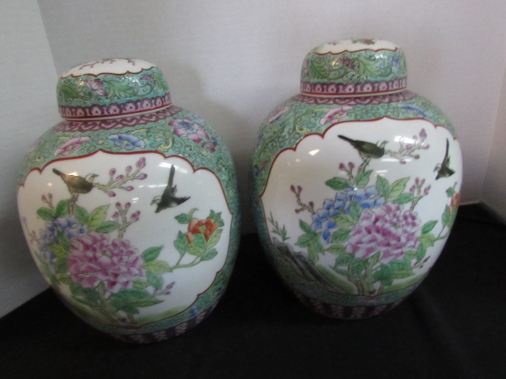 2 GINGER JARS Chinese Famille Rose Porcelain: 95.1 TWO MONUMENTAL Chinese Famille Rose Porcelain Ginger Jars. Beautifully detailed artwork. Signed on the bottom. Measuring 11 inches tall by 8 inches wide.