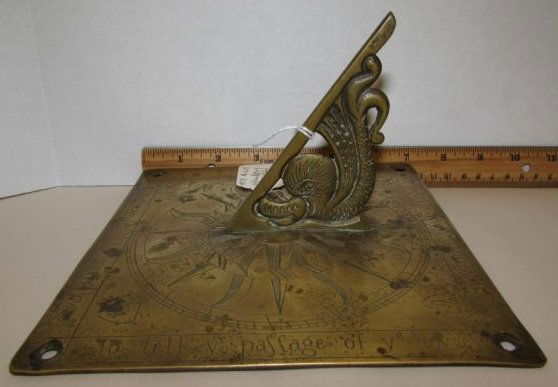 WILLIAM & MARY CHARLES II SUNDIAL BRASS 1664: 149.34 WILLIAM & MARY CHARLES II RESTORATION PERIOD ENGLISH HAND HAMMERED SUN DIAL / SUNDIAL DATED "1664". MEASURES 7" BY 7" BY 4 1/16" TALL INCLUDING GNOMON.