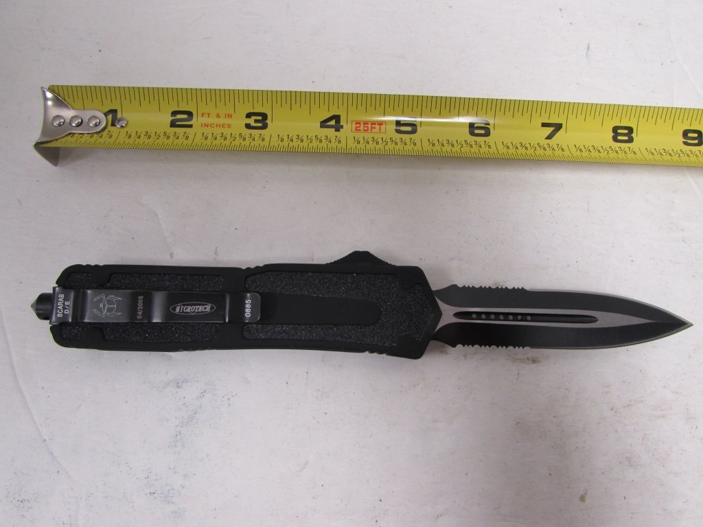 MICROTECH SCARAB D / E AUTOMATIC SERRATED KNIFE.: 3.0 MICROTECH SCARAB DOUBLE EDGED AUTOMATIC, HALF SERRATED KNIFE. 8.75" OVERALL, 3.5" BLADE, DAGGER STYLE, FLAT BLACK ON BLACK. ALUMINUM HANDLE. DOUBLE ACTION OTF TYPE. THUMB SLIDE. TACTICAL.
