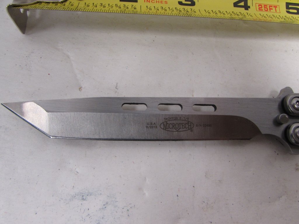 MICROTECH TACHYON II TITANIUM BALISONG KNIFE: 3.0 MICROTECH TACHYON II TITANIUM BALISONG / BUTTERFLY KNIFE. TITANIUM - SKELETONIZED STONEWASH HANDLE, 154CM STAINLESS - SINGLE EDGED TANTO BLADE. MEASURES 10" OVERALL, 4.5" BLADE, 5 3/4" CLOSED.