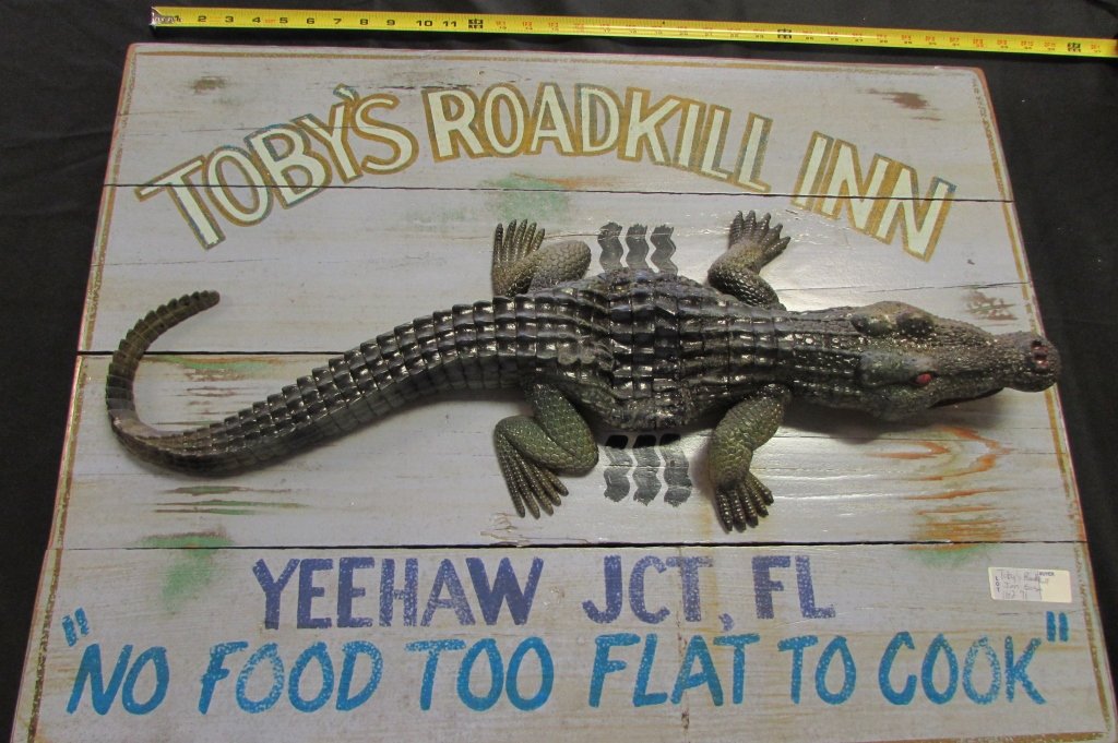 TOBY'S ROADKILL INN WOODEN HAND MADE AD SIGN: 162.71 TOBY'S ROADKILL INN WOODEN HAND PAINTED ADVERTISING SIGN. MEASURES 3' WIDE x 23" TALL.