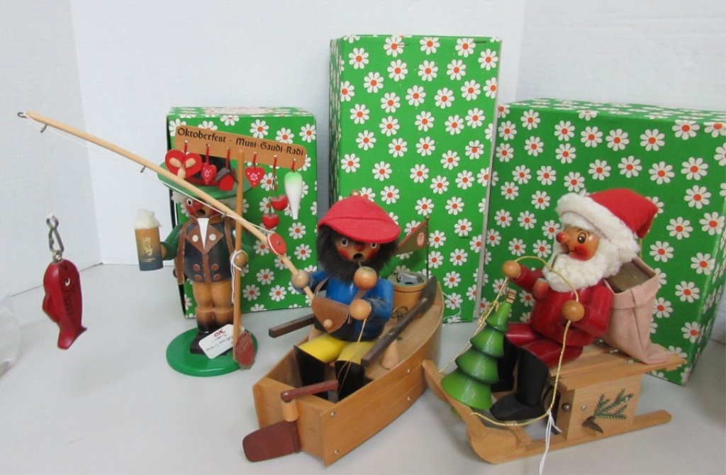 3 STEINBACH MUSICAL GERMAN WOOD CARVING SMOKERS: 169.14. INCENSE BURNERS. FISHERMAN IN BOAT, OCTOBERFEST PATRON, SANTA CLAUS ON SLED. 3 ORIGINAL BOXES INCLUDED. EXCELLENT CONDITION. PLANE IS 13" LONG.