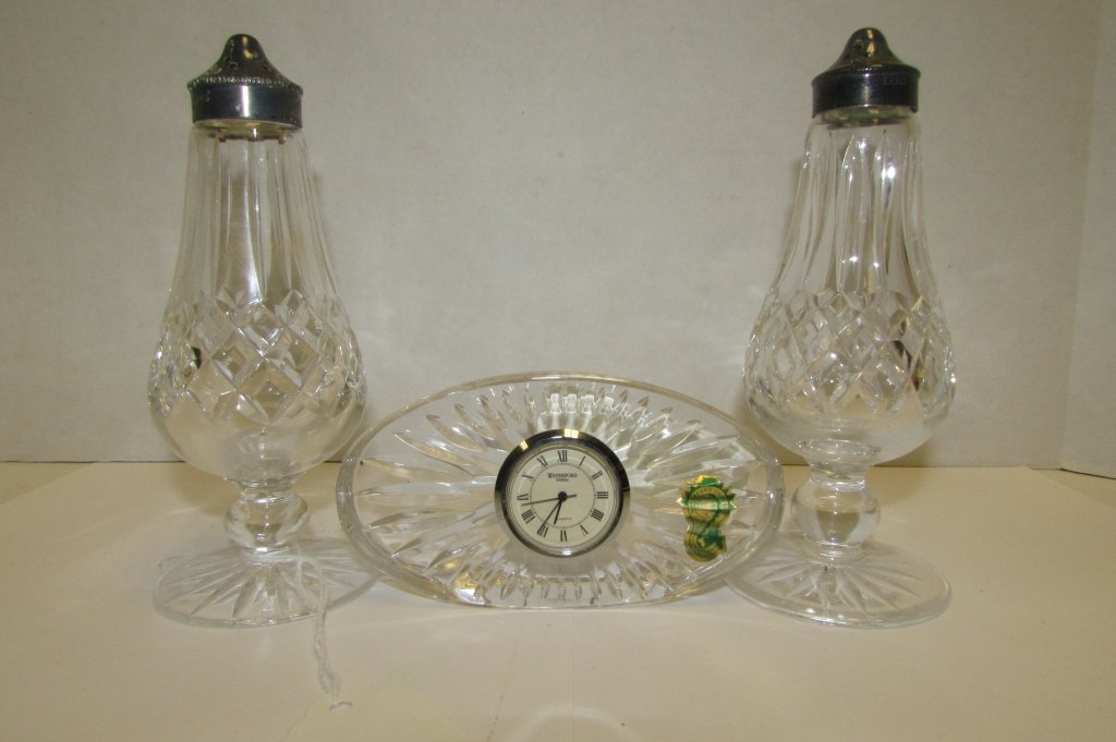 WATERFORD CLOCK, SALT & PEPPER SHAKER SET: 77.25 3 PIECE WATERFORD CRYSTAL SET. QUARTS CLOCK & SHAKER SET. STERLING SILVER ELECTROPLATED NICKEL. SHAKERS APPROX. 6" TALL x 2.5" WIDE, CLOCK APPROX. 4.75" WIDE x 1" DEEP.