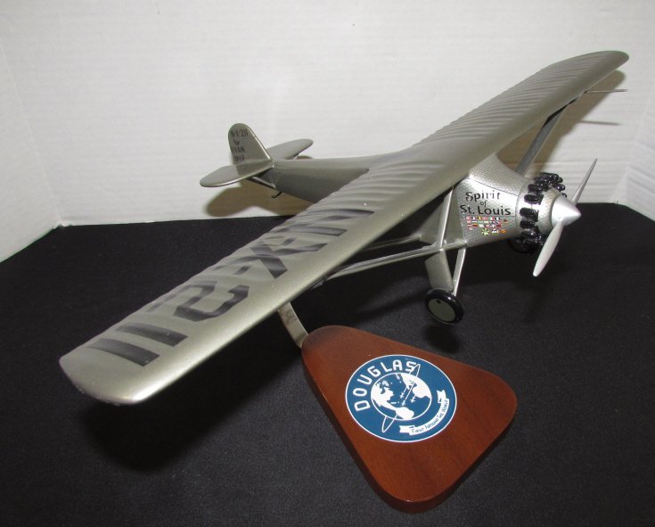MAHOGANY AIRPLANE DOUGLAS SPIRIT OF SAINT LOUIS: 194.12 MAHOGANY PLANE DOUGLAS SPIRIT OF SAINT LOUIS. MEASURES 19" BY 12" HANDPAINTED WOOD.