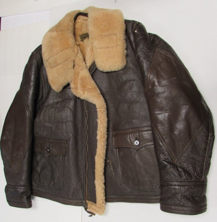 AERO US NAVY WILLIS & GEIGER BOMBER FLIGHT JACKET: 2.0 LEATHER WITH FULL SHEEP SKIN FUR LINING. US NAVY BOMBER / FLIGHT JACKET. FULL SHEARLING WOOL, GOAT SKIN TRIM, ELBOW DIAMONDS, TALON ZIPPER, SIZE 42. ONLY ONE BULLET HOLE.